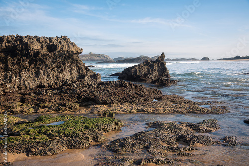 Sea waves crashing on the limestone rocks on the beach of Noja coastline, Cantabria, Spain