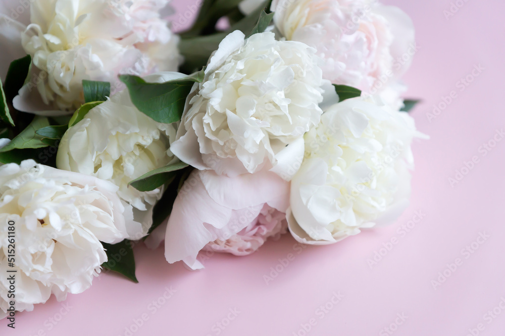Cup of coffee and white peonies on a wooden background. Top view, copy space. Cup of coffee and white peonies on a wooden background. Top view, copy space.