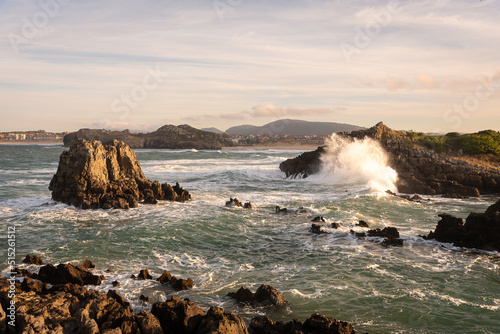 Beautiful landscape of the rock formations in the Cantabrian sea near by the coastal town of Noja at sunset, Santander, Cantabria, Spain