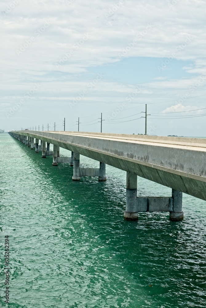 'Seven mile bridge crossing tropical waters of Moser channel under cumulus clouds in the Florida Keys'