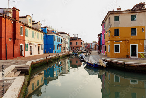 Street with colored houses on the island of Burano in the morning. Italy.
