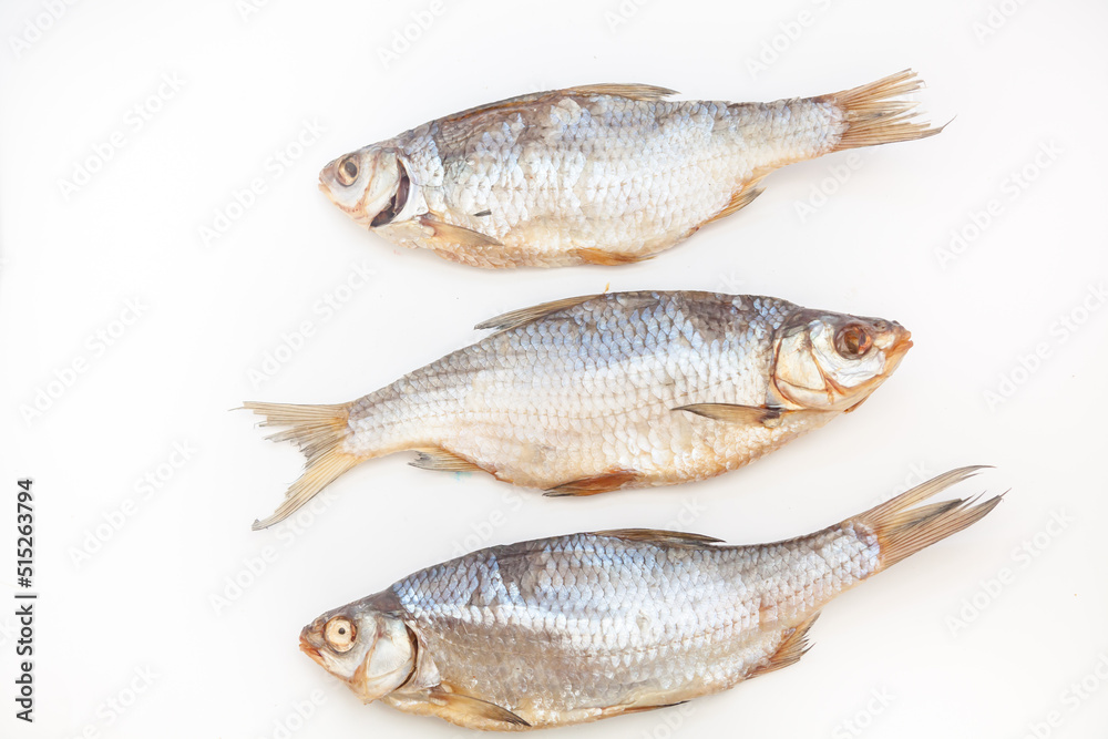 Dry fish. Seafood snack for beer. Salted sun-dried, jerked or smoked fish. Taranka, vobla. Russian or Ukrainian food. Caspian roach fish. Dead fish. High resolution photo. On white background