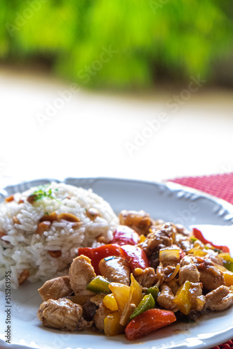 checkered chicken, typical Chinese food served with chicken and peppers, peanuts and rice