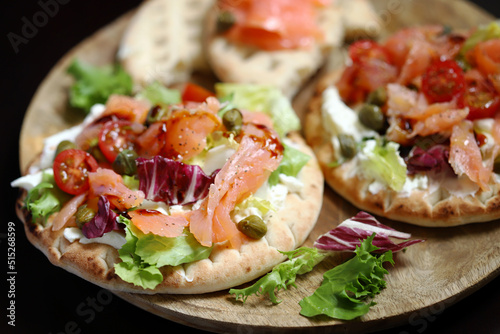 Pita with salmon, capers and vegetables.