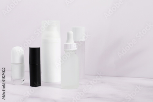 White and black mockup cos,etics bottles on marble table photo