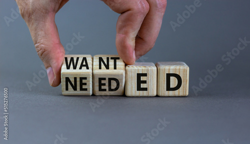 Wanted or needed symbol. Concept words Wanted or needed on wooden cubes. Businessman hand. Beautiful grey table grey background. Business Wanted or needed concept. Copy space.