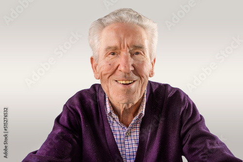 Fotografie 90 year old man in purple sweater looking at camera happy