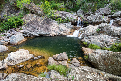 View to beautiful wild river pool on green area