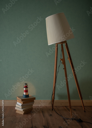 A vintage lamp looks down on a lighthouse photo