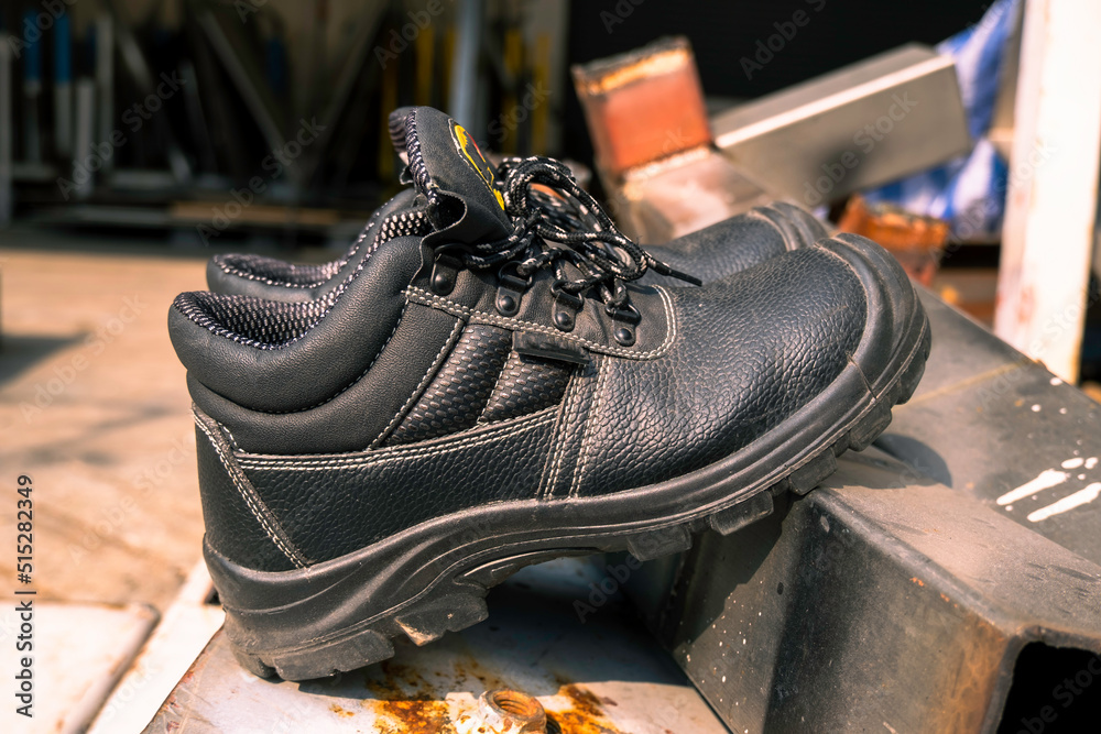 Wear safety shoes to ensure safety at work. construction workers wear safety shoes. concept