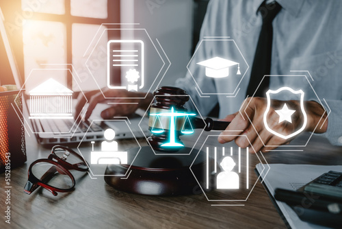 Carta da parati Justice and law concept, Male judge working on laptop computer with VR screen law icon background