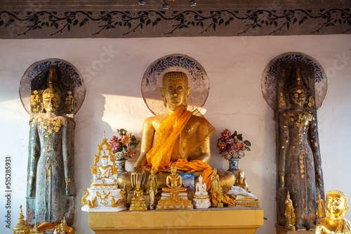 Ancient golden sitting Buddha image at Wat Phra That Choeng Chum Worawihan It has been an important sacred place of the city since ancient times. photo