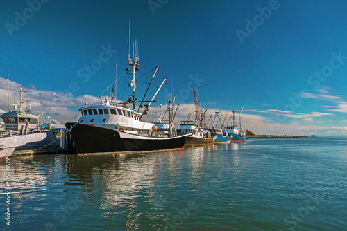 Fishing Boats in Marina and a cloudy sky. This marina is located in the Steveston area of Richmond. The fishing village formed in this place was the first settlement on the territory of Richmond