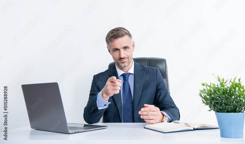 mature businessman sitting in business office. pointing finger mature businessman sitting in business office. pointing finger