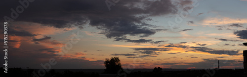Landscape at sunset. Tragic gloomy sky. The village in the Budjak steppe. Panorama. Crimson twilight. photo