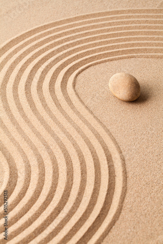 stone on sand with zen pattern. meditation harmony concept.