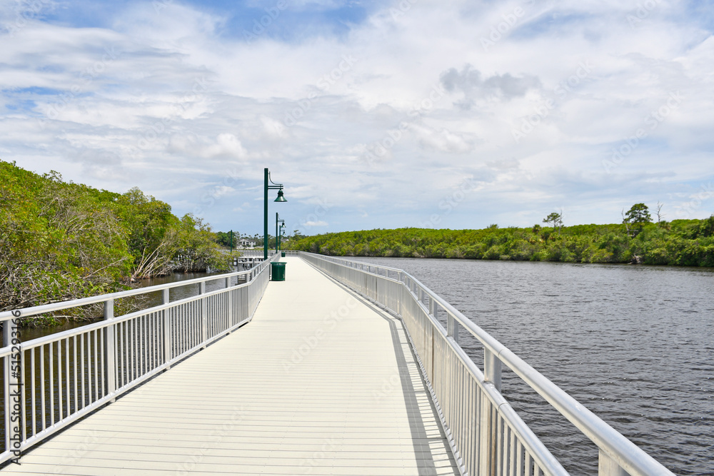 Fishing, walking pier along the St Lucie River estuary in Port St Lucie, Florida