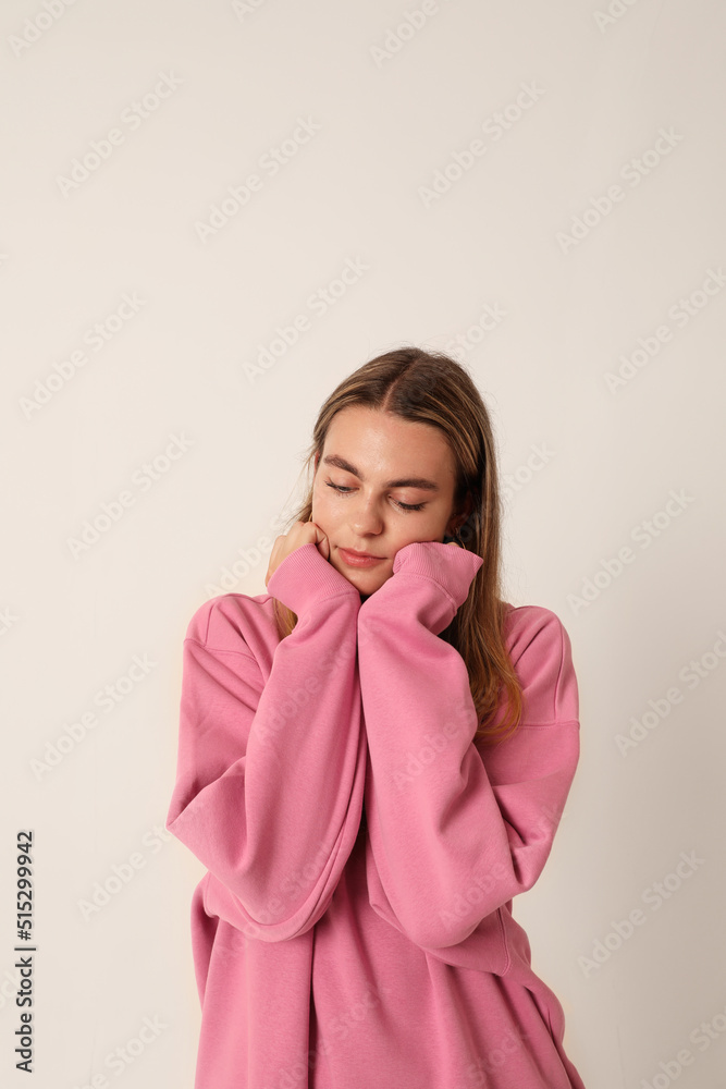 Sad teenage girl wearing pink dress, looking aside. Mindset concept. Vertical. Sad teenage girl wearing pink dress, looking aside. Mindset concept. Vertical.