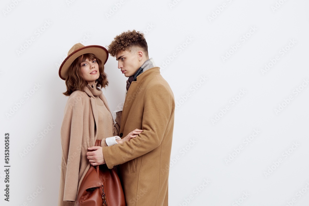 a happy couple is standing in autumn , stylish clothes and no need to hug each other looking at each other a happy couple is standing in autumn , stylish clothes and no need to hug each other looking at each other