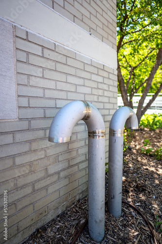 Curved ventilation pipe used to equalize pressure and provide air to an underground pumping wastewater sewage station. photo