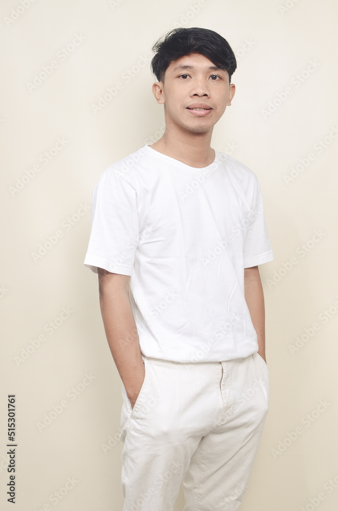Portrait of cool young asian man wearing white clothes on isolated background Portrait of cool young asian man wearing white clothes on isolated background