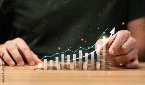 Businessmen plan their business finances to grow in the future with graphs and arrows virtual hologram chart.from investment. Return on Stocks. business strategy. Development to success and motivation