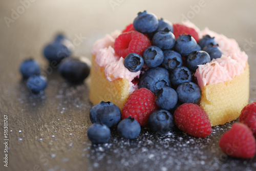 Cake with cream covered with juicy berries.