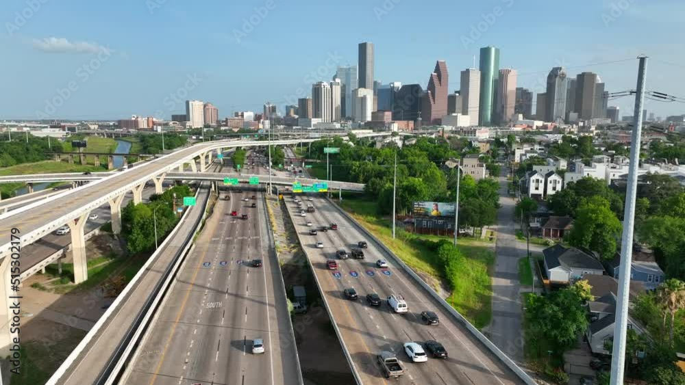 Traffic on interstate. Aerial of Houston Texas skyline as commuters drive on I-45. Rising aerial reveal during golden hour. Traffic on interstate. Aerial of Houston Texas skyline as commuters drive on I-45. Rising aerial reveal during golden hour.