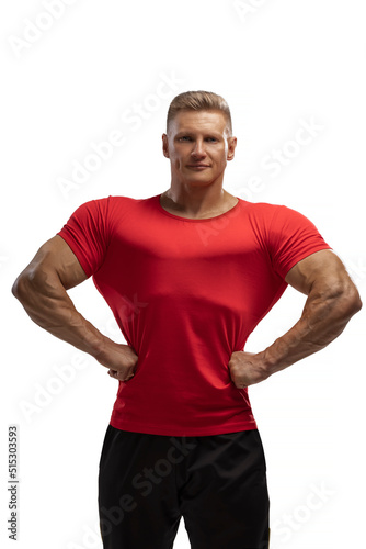 Handsome athletic man posing in a T-shirt on a white background