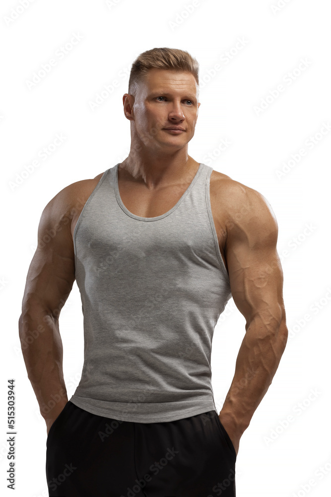 Hight-level bodybuilder posing in tank-top in white background Hight-level bodybuilder posing in tank-top in white background