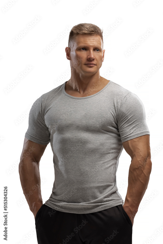 Handsome athletic man posing in T-shirt on a white background Handsome athletic man posing in T-shirt on a white background