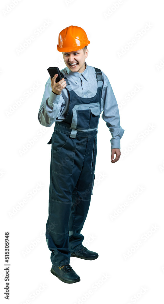 isolated. male engineer, builder in workwear and helmet emotionally speaks on the phone isolated. male engineer, builder in workwear and helmet emotionally speaks on the phone