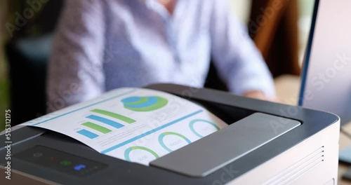 Printer prints documents financial business charts and working woman