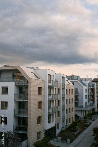 Modern apartment building with green zones below. Concept of an ecofriendly real estate investment in Europe