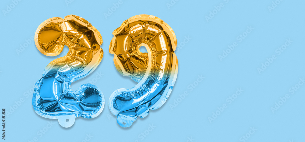 Rainbow foil balloon number, digit twenty nine on a blue background. Birthday greeting card with inscription 29. Top view. Numerical digit. Celebration event, template. Banner Rainbow foil balloon number, digit twenty nine on a blue background. Birthday greeting card with inscription 29. Top view. Numerical digit. Celebration event, template. Banner