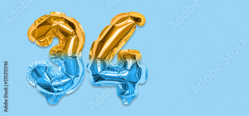 Rainbow foil balloon number, digit thirty four on a blue background. Birthday greeting card with inscription 34. Top view. Numerical digit. Celebration event, template. Banner photo