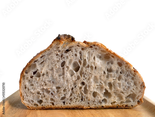Close up Side view inside of baked brown homemade sourdough on the wooden plate, isolated, plain background with copy space and clipping path photo