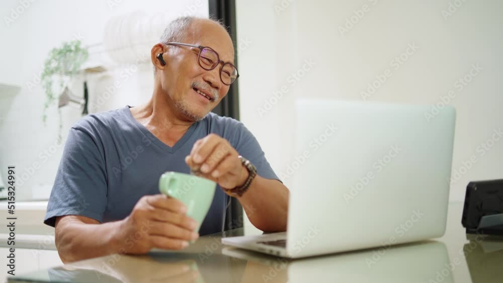 Joyful relaxed Asian Senior Adult man using laptop at home, Smiling face, Chinese male laughing