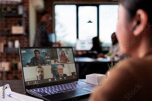 Office employee using video call telework to chat with colleagues on laptop, talking on remote videoconference meeting. Webcam internet conversation on online teleconference with headphones.