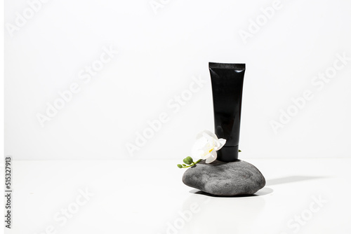 Black jar mockup for vitamins on natural stone on dark background