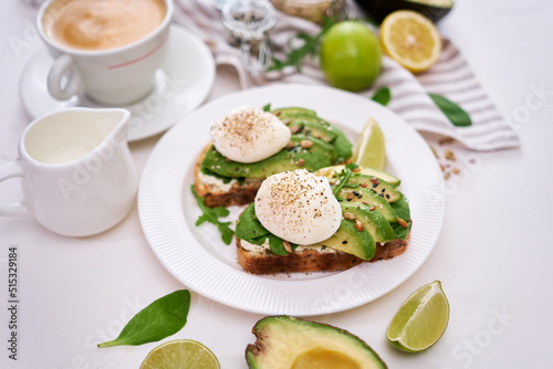 Freshly made poached egg and Avocado toasts on light grey background