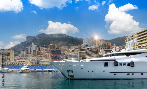 France, French Riviera, Monte Carlo marina with luxury yachts and cars in Monaco bay. photo
