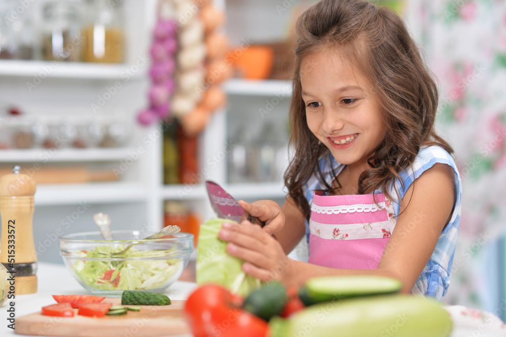Cute happy girl coocking salad on kitchen Cute happy girl coocking salad on kitchen