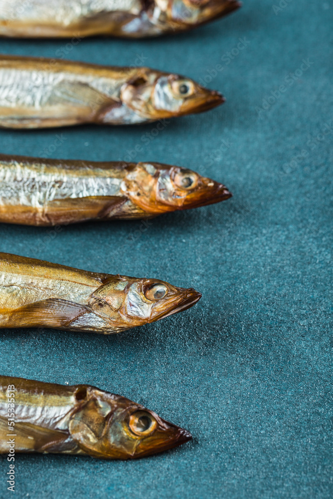 A pattern of smoked capelin on a blue background. A pattern of smoked capelin on a blue background.