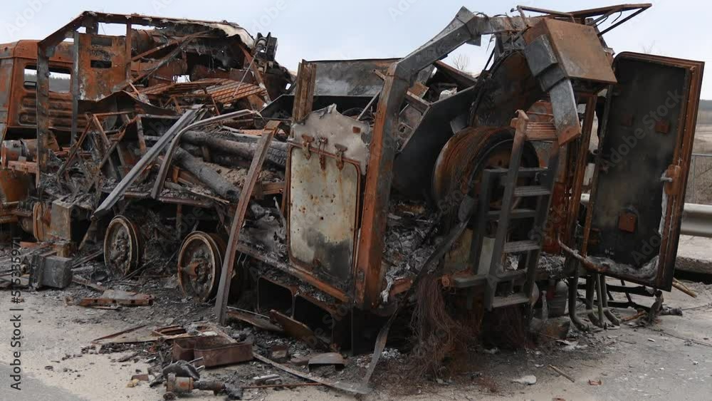 Burnt military vehicles of Russian soldiers on the bridge across the river. Cars after being hit by rockets, mines. Rusty cars. Charred car parts. Burnt military vehicles of Russian soldiers on the bridge across the river. Cars after being hit by rockets, mines. Rusty cars. Charred car parts.