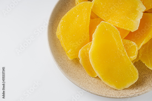 delicious dried mango on a white acrylic background