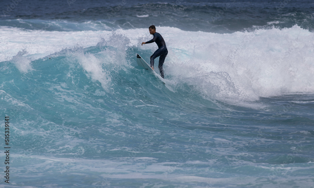 PUERTO DE SANTIAGO, TENERIFE - JUNE 2022: surfer riding the waves in Tenerife