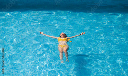 top view of woman floating in swimming pool © Melinda Nagy
