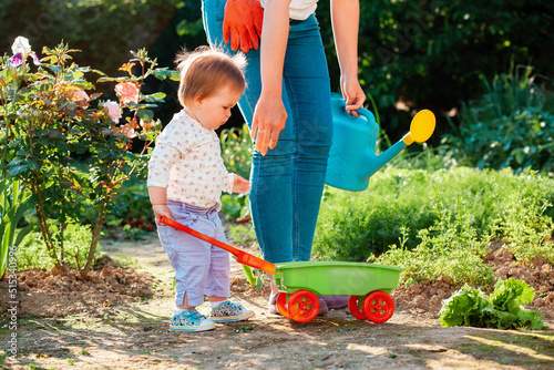 Obraz na plátně A mother teaches her child to take care of the garden