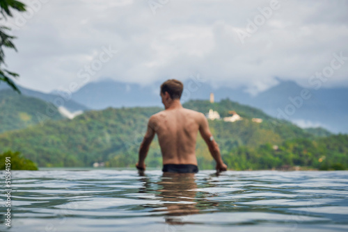 Diabetes patient in a swimmingpool with an waterproof CGM (Continuous Glucose Monitor) device to measure real-time blood sugar for a healthy lifestyle without setbacks for a good healthcare.